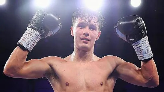 Garan Croft holds up his hands in celebration after victory