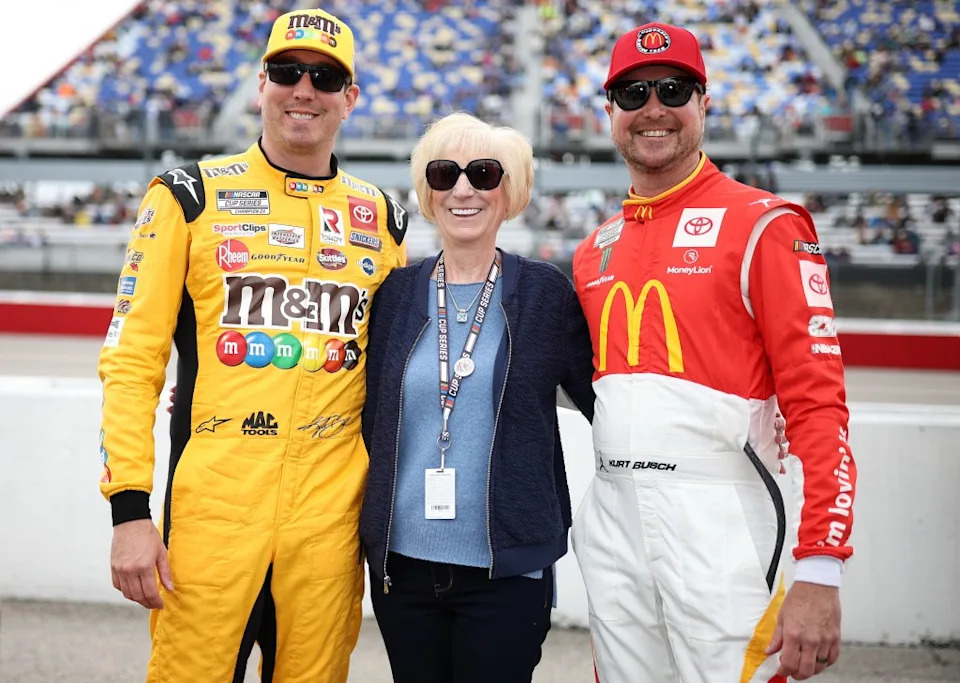 Kyle Busch, driver of the #18 M&M’s Toyota, and Kurt Busch, driver of the #45 McDonald’s Throwback Toyota, pose with their mother, Gaye Busch prior to the NASCAR Cup Series Goodyear 400 at Darlington Raceway on May 8, 2022. Getty Images