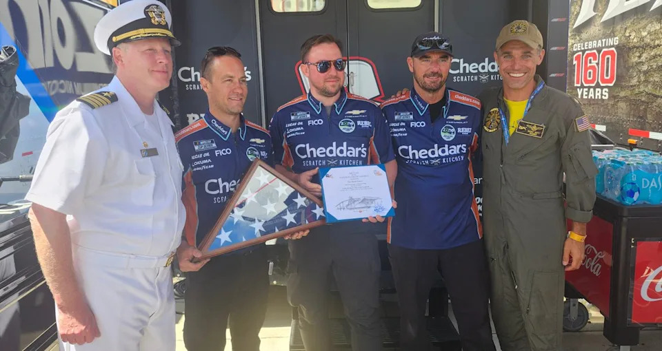 Capt. Kyle Thomas, commanding officer of the Navy Reserve Center on North Island, and Lt. Cmdr. Ricky Hoyt present Austin Hill