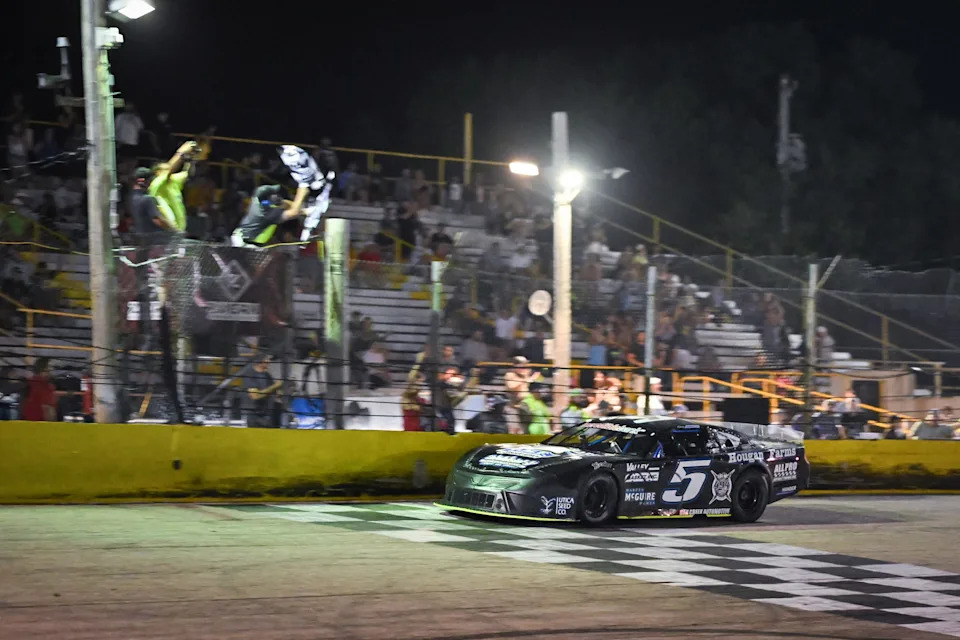 Casey Johnson (5) takes the checkered flag to win the 47th Slinger Nationals on Tuesday, July 14, 2026, at Slinger Speedway in Slinger, Wisconsin.