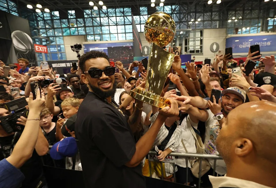 Karl-Anthony Towns holds up the NBA Championship Trophy at Fanatics Fest 2026 at the Jacob Javits Center on July 18, 2026 in New York City. Kevin Mazur/Getty Images for Fan