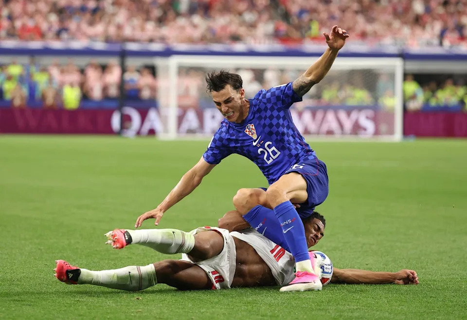 Bellingham slides through Croatia’s Petar Musa (Getty)