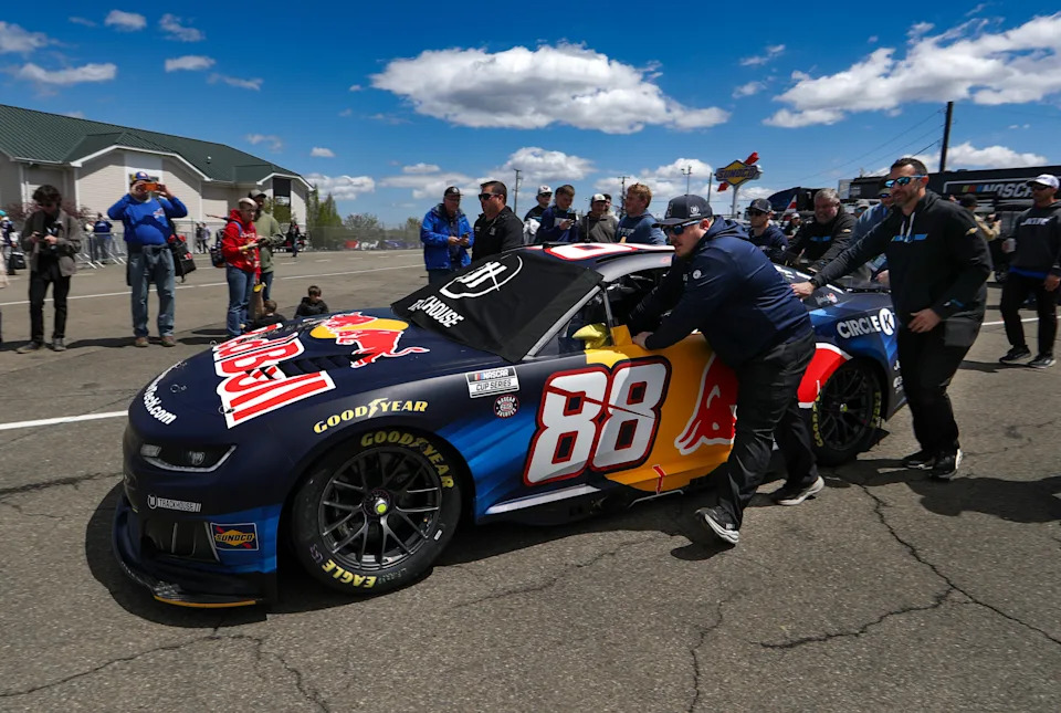 May 10, 2026; Watkins Glen, New York, USA; Crew members push the car of NASCAR Cup Series driver Connor Zilisch (88) to pit road prior to the Go Bowling at The Glen at Watkins Glen International. Mandatory Credit: Matthew O'Haren-Imagn Images