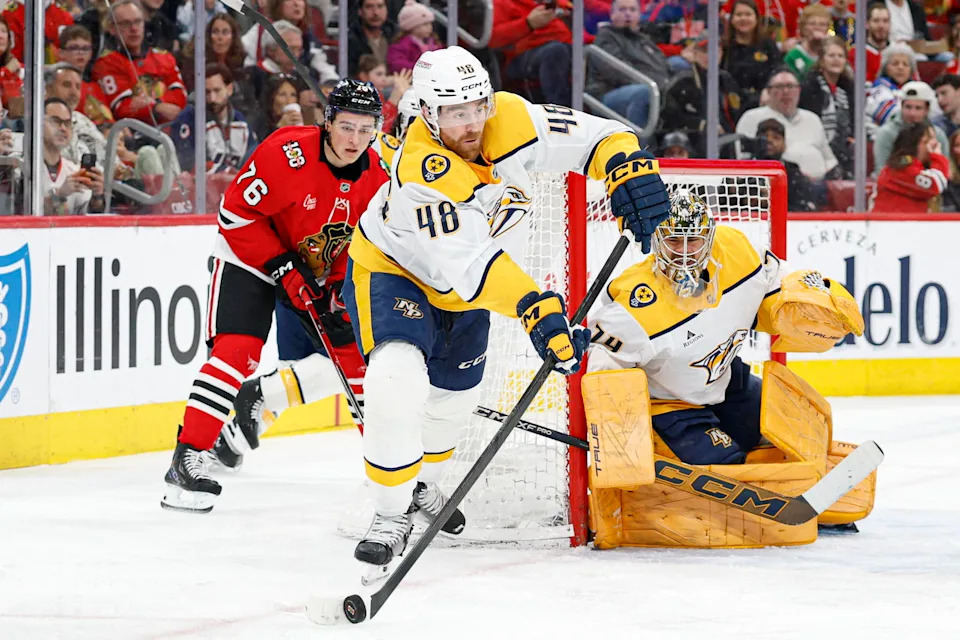Mar 22, 2026; Chicago, Illinois, USA; Nashville Predators defensemanNick Perbix(48) passes the puck away from Chicago Blackhawks left wingNickLardis (76) during the first period at United Center. Mandatory Credit: Kamil Krzaczynski-Imagn Images