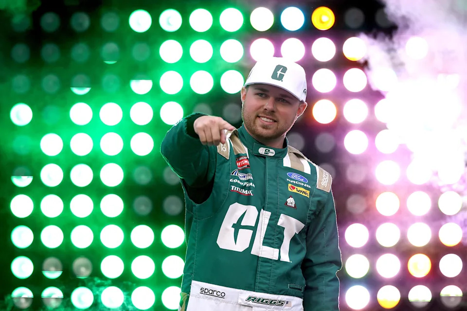 Layne Riggs, driver of the #34 Ford, waves to fans as he walks onstage during driver intros prior to the NASCAR Craftsman Truck Series North Carolina Education Lottery 200 at Charlotte Motor Speedway on May 22, 2026 in Concord, North Carolina.
