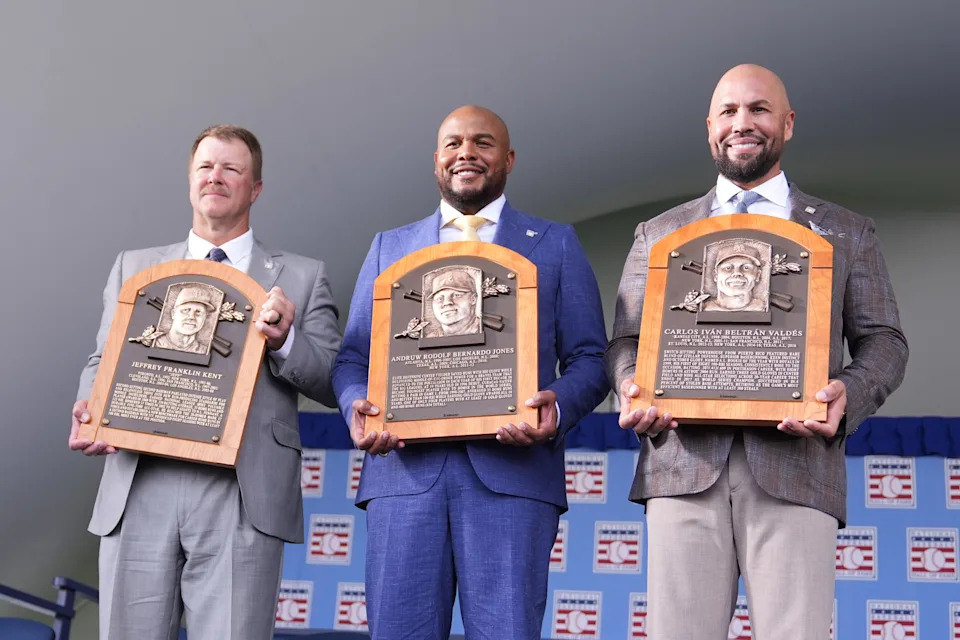 Jeff Kent, Andruw Jones and Carlos Beltran pose for a photo with their Baseball Hall of Fame plaques in Cooperstown, N.Y.