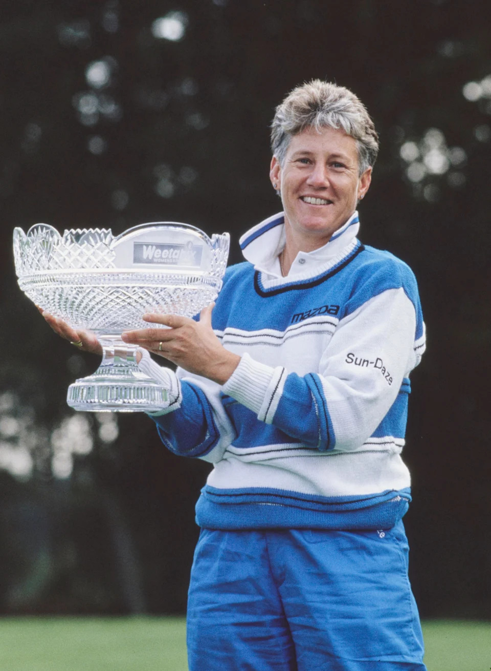 Patty Sheehan of the United States holds the champion golfer trophy after winning the Weetabix Women's British Open golf tournament on 15th August 1992 at the Woburn Golf and Country Club Duke's Course in Little Brickhill, near Milton Keynes, England. 
