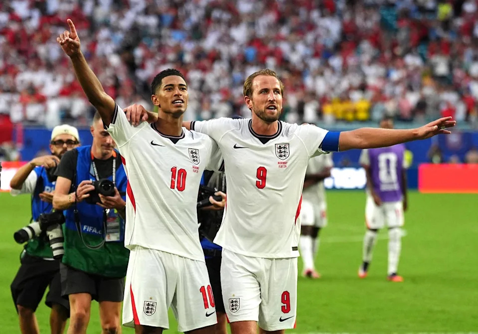 Jude Bellingham and Harry Kane salute the fans after reaching the semi-finals (Martin Rickett/PA)