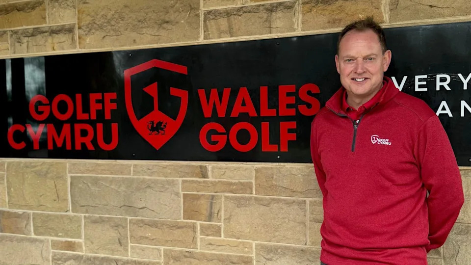 Gareth Jenkins next to a Wales Golf sign 