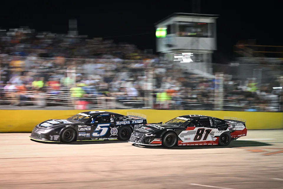 Casey Johnson (5) passes Carson Brown for the lead after a restart with four laps to go in the 47th Slinger Nationals on Tuesday, July 14, 2026, at Slinger Speedway in Slinger, Wisconsin.