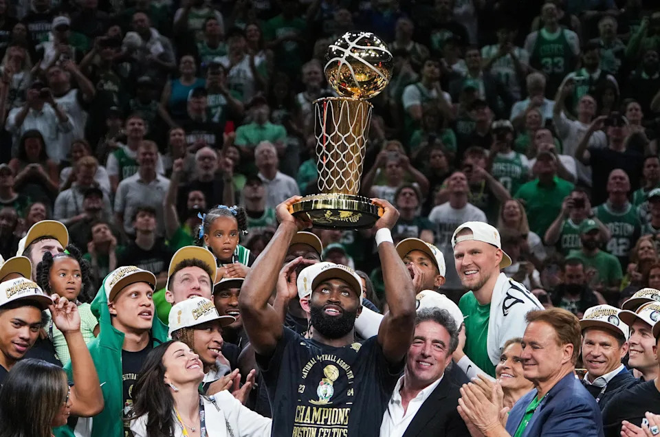 Boston, MA – June 17: Boston Celtics guard Jaylen Brown hoists the Larry O'Brien Championship trophy at the end of Game 5 of the 2024 NBA Finals. (Photo by Barry Chin/The Boston Globe via Getty Images) | Boston Globe via Getty Images