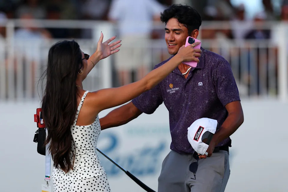 Ricky Castillo of the United States reacts with his girlfriend Alexis Molina after his winning putt on the 18th green during the final round of the Puerto Rico Open 2026 at Grand Reserve Golf Club on March 08, 2026 in Rio Grande, Puerto Rico.