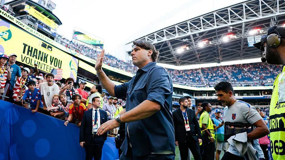 Mauricio Pochettino waves to fans as he leaves the pitch