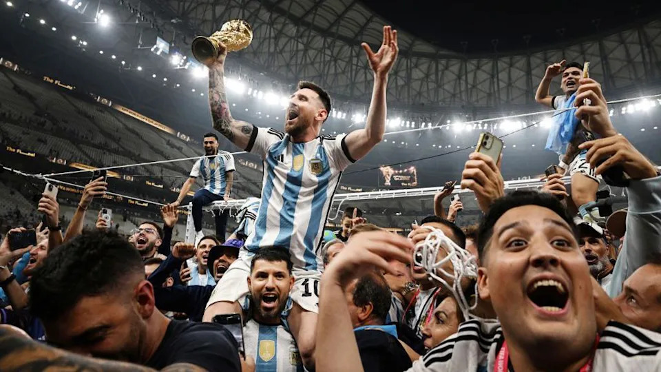 Lionel Messi celebrates while sat on the shoulders of Sergio Aguero