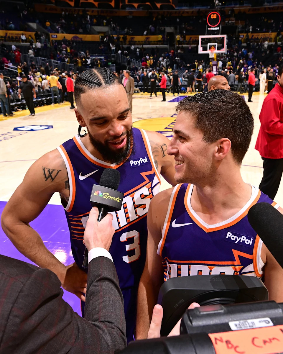 LOS ANGELES, CA – DECEMBER 1: Dillon Brooks #3 and Collin Gillespie #12 of the <a class="link " href="https://sports.yahoo.com/nba/teams/phoenix/" data-i13n="sec:content-canvas;subsec:anchor_text;elm:context_link" data-ylk="slk:Phoenix Suns;sec:content-canvas;subsec:anchor_text;elm:context_link;itc:0" data-yga="{"yLinkElement":"context_link","yModuleName":"content-canvas","yLinkText":"Phoenix Suns","ySubModuleName":"anchor_text","yHasCommerce":false}">Phoenix Suns</a> talks to the media after the game against the <a class="link " href="https://sports.yahoo.com/nba/teams/la-lakers/" data-i13n="sec:content-canvas;subsec:anchor_text;elm:context_link" data-ylk="slk:Los Angeles Lakers;sec:content-canvas;subsec:anchor_text;elm:context_link;itc:0" data-yga="{"yLinkElement":"context_link","yModuleName":"content-canvas","yLinkText":"Los Angeles Lakers","ySubModuleName":"anchor_text","yHasCommerce":false}">Los Angeles Lakers</a> on December 1, 2025 at Crypto.Com Arena in Los Angeles, California. NOTE TO USER: User expressly acknowledges and agrees that, by downloading and/or using this Photograph, user is consenting to the terms and conditions of the Getty Images License Agreement. Mandatory Copyright Notice: Copyright 2025 NBAE (Photo by Adam Pantozzi/NBAE via Getty Images) | NBAE via Getty Images