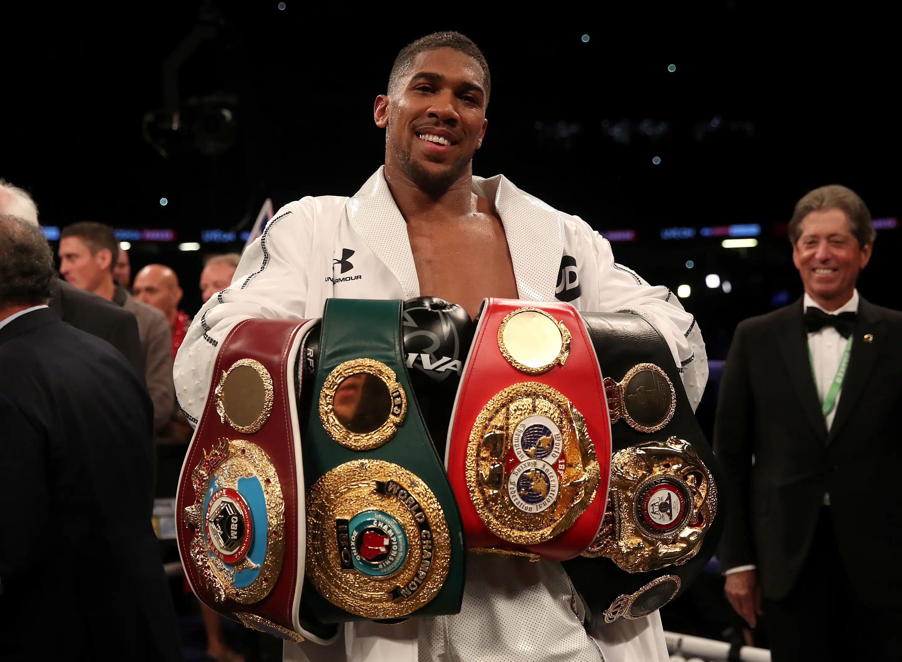 Anthony Joshua celebrates with his belts after victory over Joseph Parker in their WBA, IBF, WBO and IBO Heavyweight Championship contest at the Principality Stadium, Cardiff. (Photo by Nick Potts/PA Images via Getty Images)